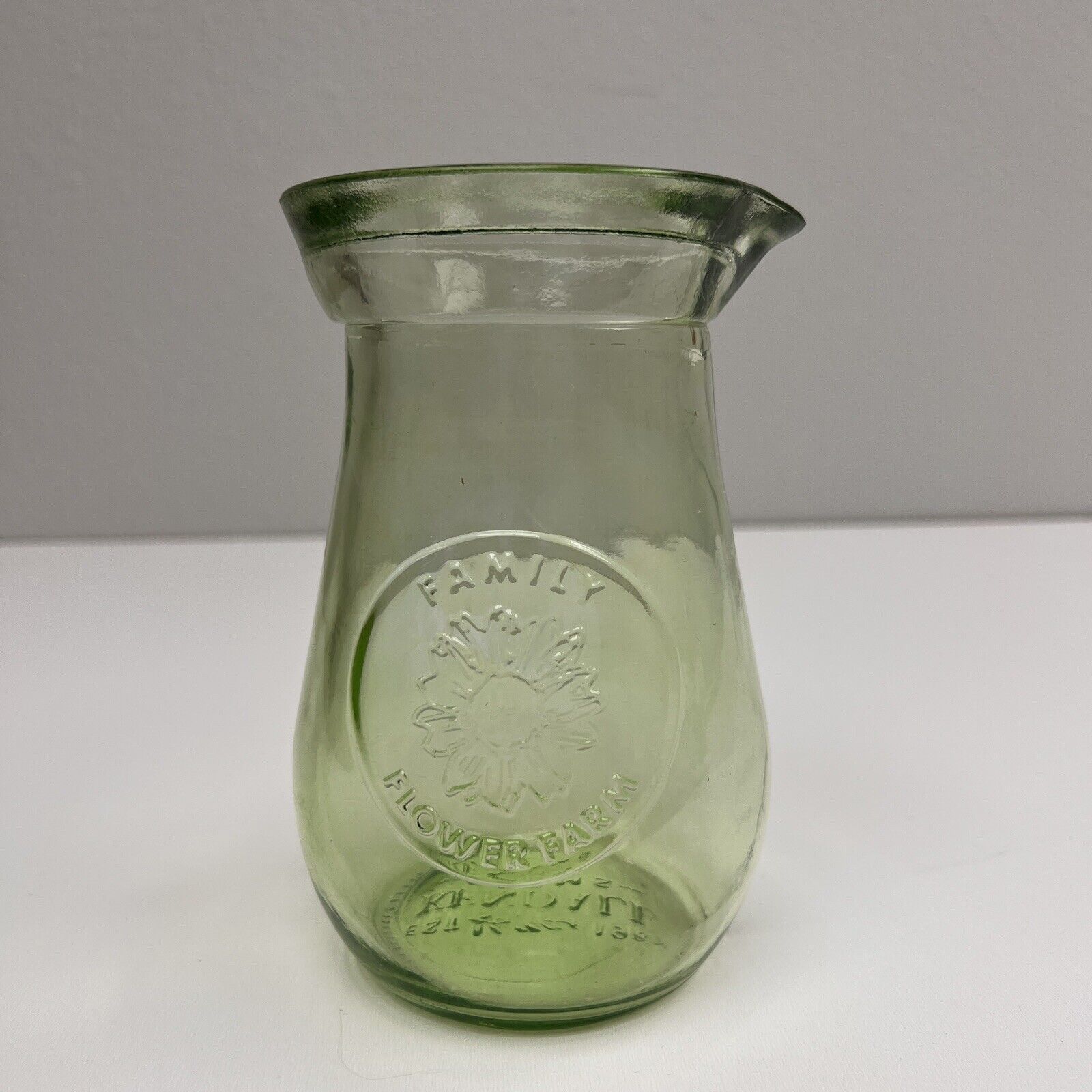 Kendall Farms green glass Flowers vase. 6 1/2” tall